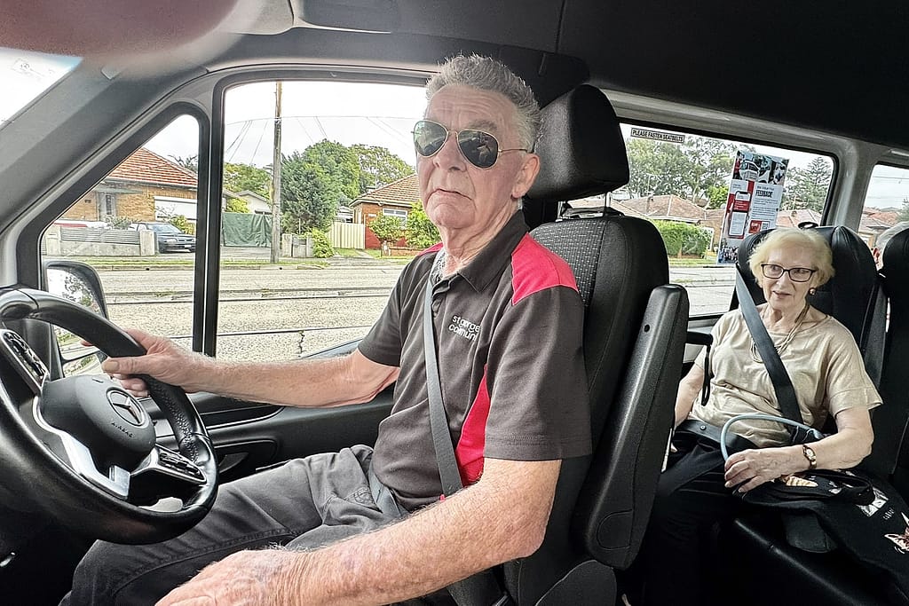 Robin driving the St George Community bus with Eileen on board heading to bingo
